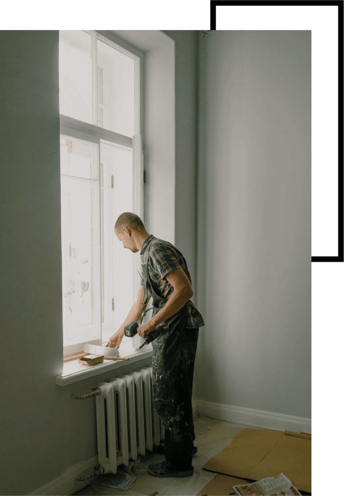 A man standing in front of a window.