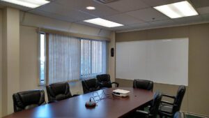 A conference room with four chairs and a table.