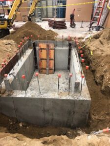 A concrete slab being poured for the foundation of a house.