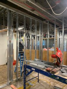 A man working on a construction site with a saw.