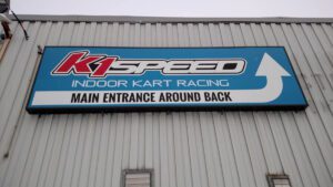 A sign for k 1 speed indoor kart racing.