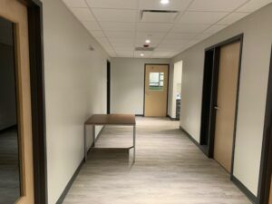 A hallway with a table and chairs in it