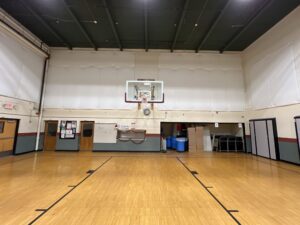 An empty basketball court with a hoop.