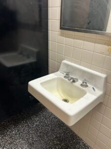 A white sink in a public restroom.