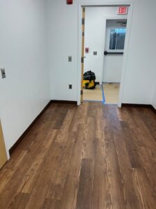 Long brown wooden floor hallway.