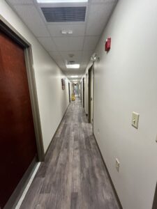 Office hallway with brown doors.